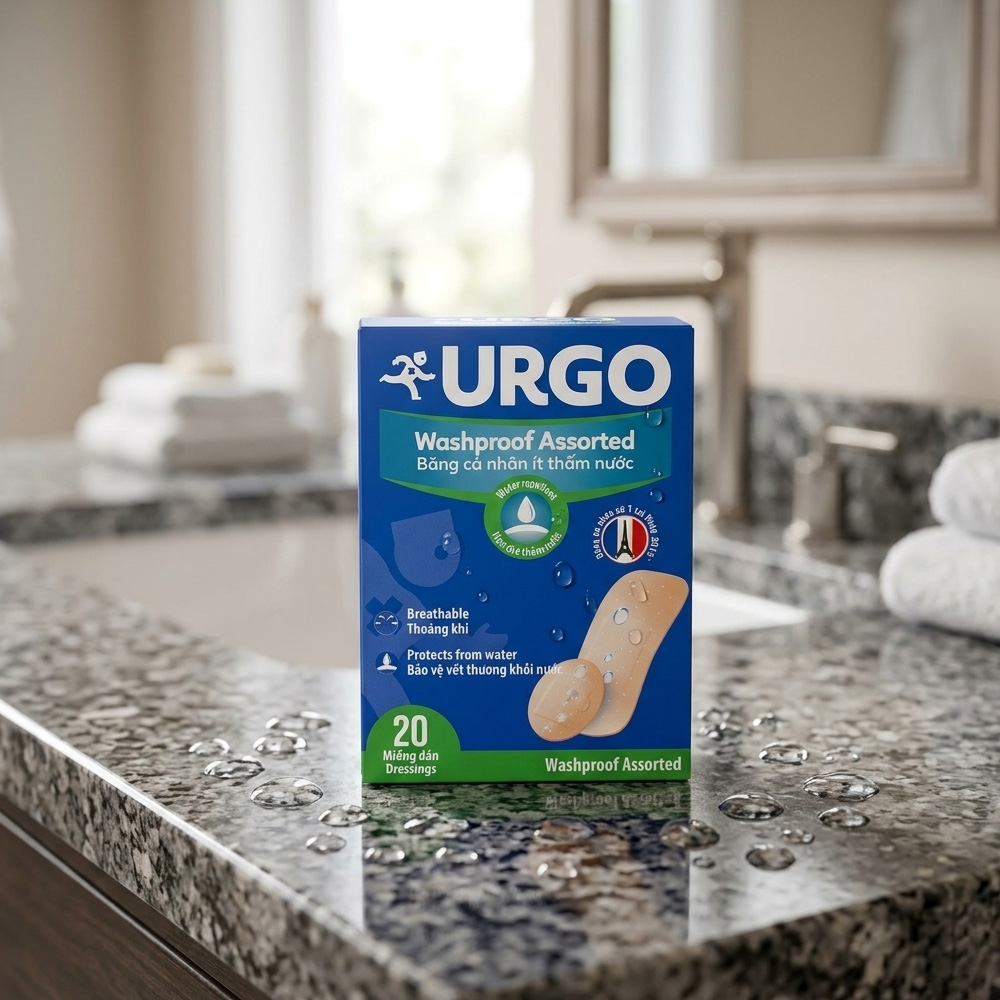 Urgo Washproof Assorted Bandage 4 Sizes 20 Pcs - Băng cá nhân ít thấm nước với bốn kích cỡ, phù hợp cho nhiều vị trí trên da. Nền băng có các lỗ thoát khí nhỏ, còn lớp gạc không dính vào vết thương nên thuận tiện hơn khi thay băng. Urgo-Washproof-Assorted-Bandage-4-Sizes-20-Pcs-1